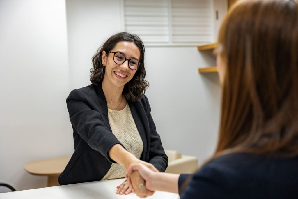 pexels-photo-18848927-18848927 Businesswomen shaking hands in an office, representing a successful job interview or partnership.