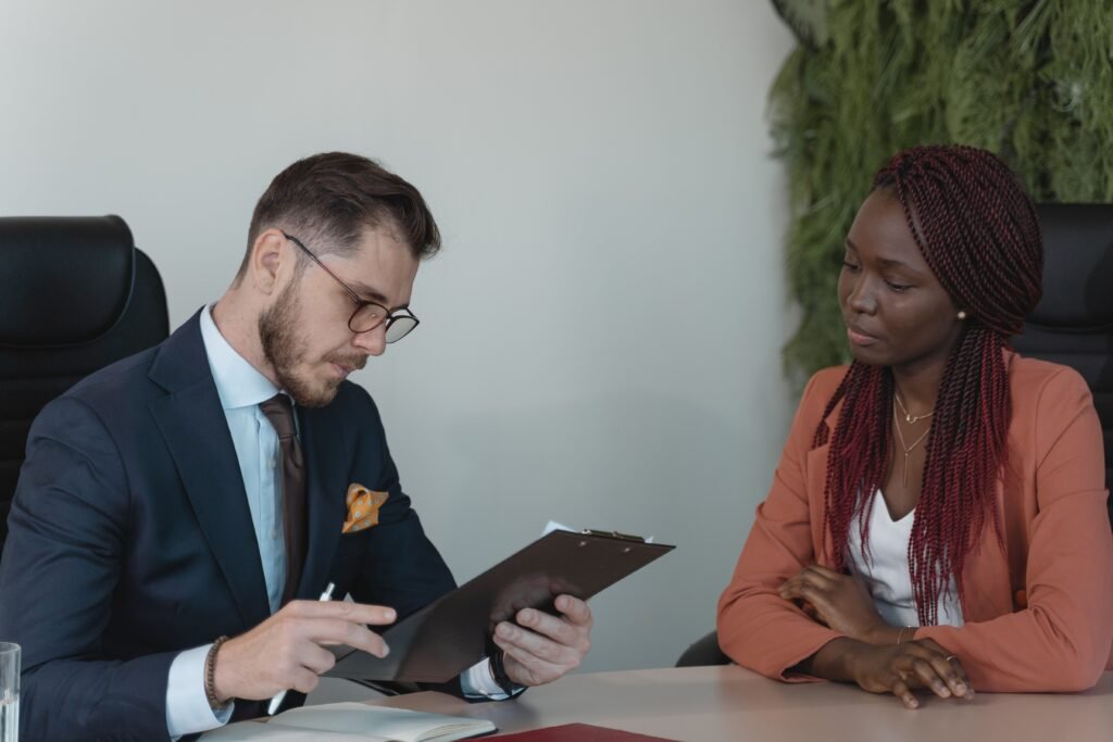pexels-photo-5439455-5439455 A man and woman engaging in a job interview in a modern office setting.